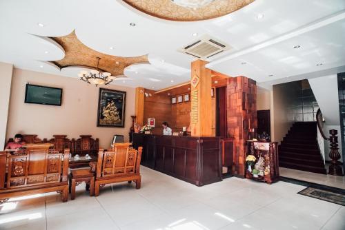 a lobby of a building with wooden furniture at Sunflowers Hotel Airport in Ho Chi Minh City