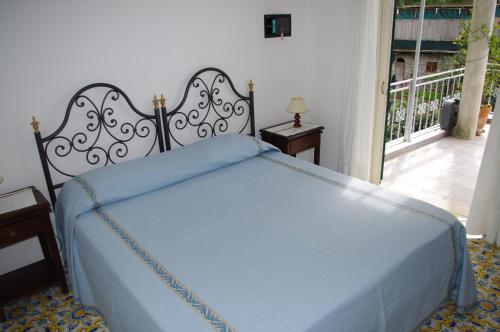 a bed with two pillows on top of it at Casa Fortunata in Positano