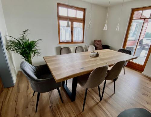 a dining room with a wooden table and chairs at Ferienhaus mit 5* Luxus im Schwarzwald in Gemeinde Aichhalden