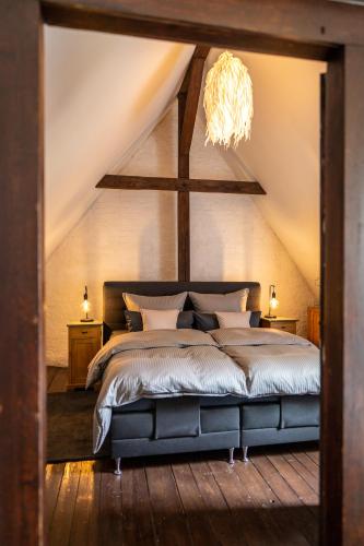 a bedroom with a large bed with a ceiling at Ferienwohnung am KunstTurm in Weimar