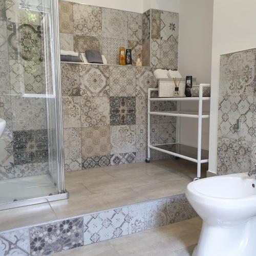a bathroom with a shower and a sink and a toilet at Opera Prima 28 in Palermo
