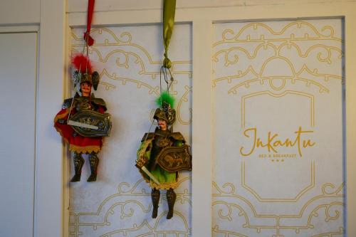 two ornaments are hanging on a wall at Inkantu B&B in Terrasini