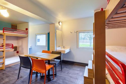 a room with a table and chairs and a bunk bed at hotelF1 Paris Porte de Montreuil in Bagnolet