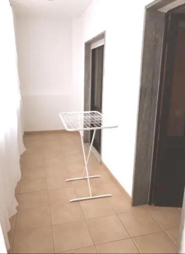 a white chair sitting on a tile floor in a room at cosy2bedroomapartment in Loulé
