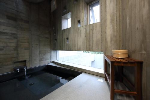 a bathroom with a bath tub and a sink at Penlai Home in Fengli