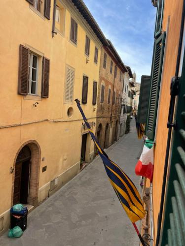 a view of an alley with flags on a building at Guesthouse da Idolina dal 1946 in Montalcino