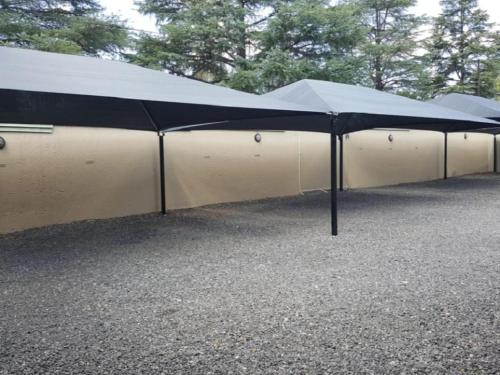 a large black and white tent in a parking lot at Euforia Guesthouse in Middelburg