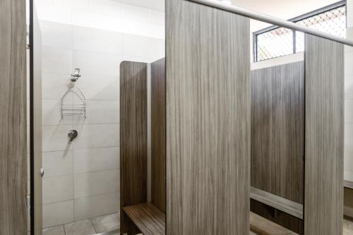 a bathroom with a shower and a glass door at Ningaloo Caravan and Holiday Resort in Exmouth