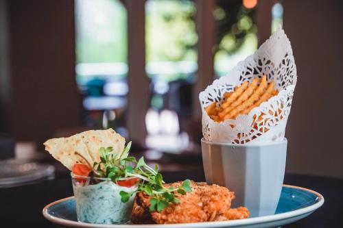 a plate of food with carrots on a table at The Hotel Unforgettable - Hotel Tiliana by Homoky Hotels & Spa in Budapest