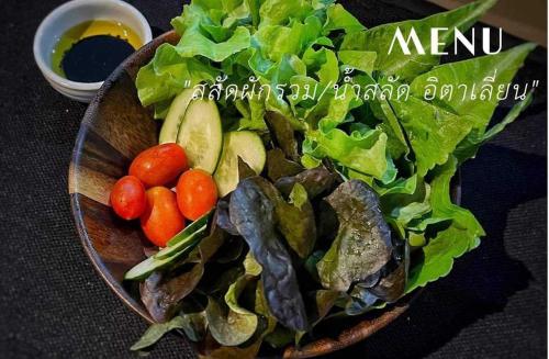 a bowl of salad with tomatoes and lettuce at Livist Resort phetchabun in Phetchabun