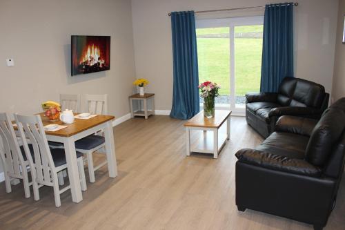 a living room with a table and a couch at Plawsworth Hall Serviced Cottages and Apartments in Durham
