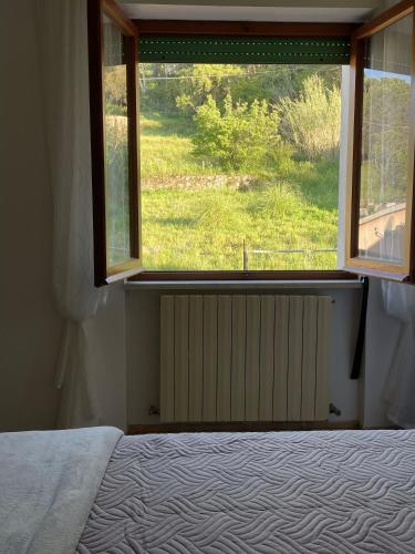 a bedroom with a bed and a large window at B&B Casa Gianfranca in Portoferraio