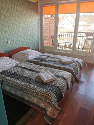 a bedroom with two beds with towels on them at Dom Wczasowy Radość in Rewal