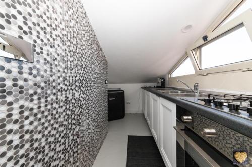 a kitchen with a sink and a counter top at SuiteFrattini Private Spa Rooftop in Rome