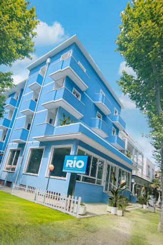 a blue building with a nico sign in front of it at Hotel Rio Beach & Breakfast in Cesenatico