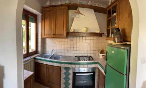 a kitchen with a green refrigerator and a sink at B&B Casa Gianfranca in Portoferraio