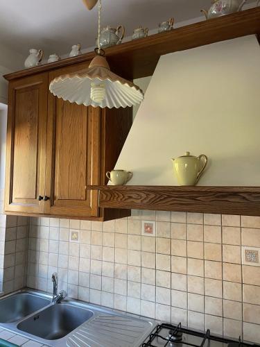 a kitchen with a sink and a stove top at B&B Casa Gianfranca in Portoferraio