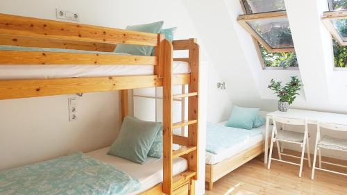 a room with two bunk beds and a table at Shantee House in Budapest
