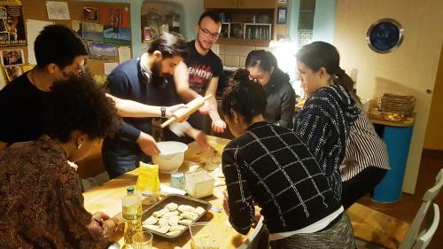 a group of people standing around a table with food at Shantee House in Budapest