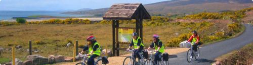 a group of people riding bikes down a road at Beautiful 3-Bed House in Knock in Knock