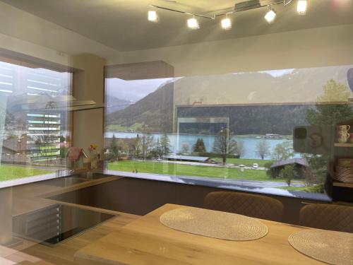a kitchen with a large window with a view of a lake at Appartement Mountain Lake in Maurach