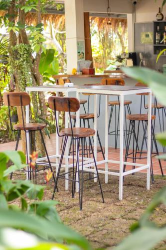 a group of stools sitting around a white table at TARA LODGE Haven of peace in Kep