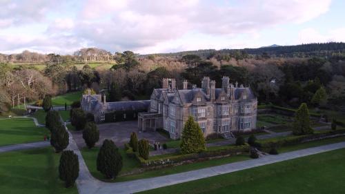 an aerial view of a large castle with trees at Brook Lodge Boutique Hotel in Killarney
