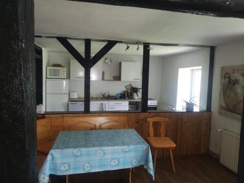 a room with a table and a kitchen with a table sidx sidx at Ferienhaus Salmtal Himmerod in Großlittgen