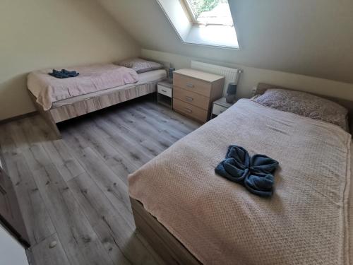 A bed or beds in a room at Sókristály Vendégház