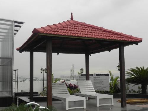 a pavilion with white chairs and a red roof at Regenta Central RS Chennai OMR SIPCOT in Chennai