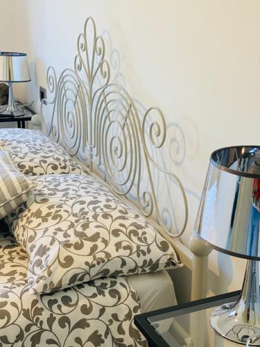 a bedroom with a bed with a metal headboard at Green House in campagna in Melara