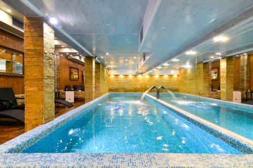 a large swimming pool in a hotel room at Premier Prezident Garni Hotel and Spa in Sremski Karlovci