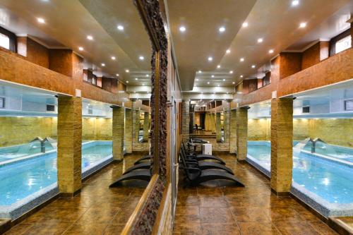 a swimming pool in a building with rows of pools at Premier Prezident Garni Hotel and Spa in Sremski Karlovci