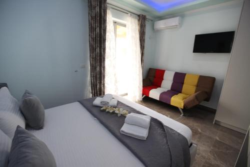 a hotel room with a bed and a couch at Hotel Erviliano in Borsh