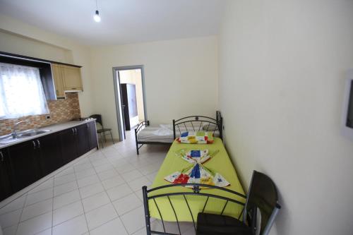 a small kitchen with a table in a room at Hotel Erviliano in Borsh