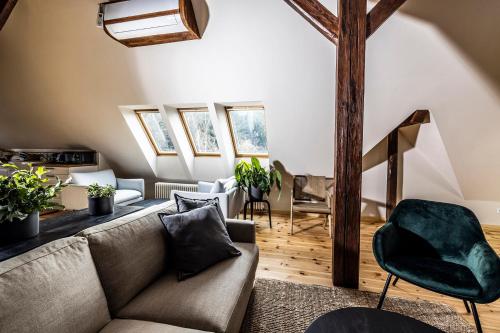 a living room with a couch and chairs at Vila Čapek in Branžež