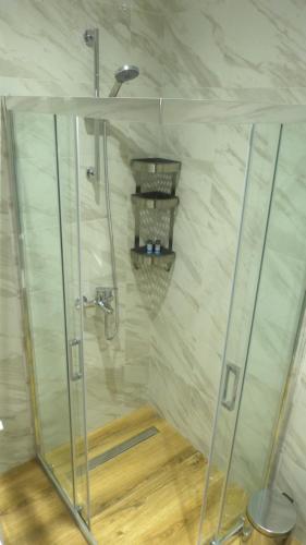 a shower with a glass door in a bathroom at Saroko Residence in Corfu Town