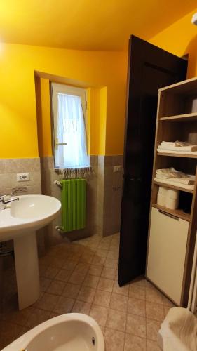 a bathroom with a sink and a toilet and a window at Casa Beatrice in Bolsena