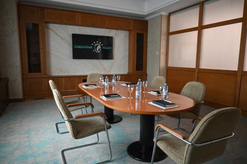 a conference room with a wooden table and chairs at Aleksandar Palace Hotel Congress Center & SPA in Skopje