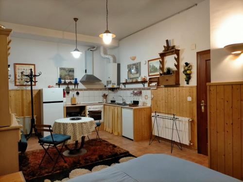 a kitchen with a table and chairs in a room at ALL IN ONE. TODO EN UNO. in Bérriz