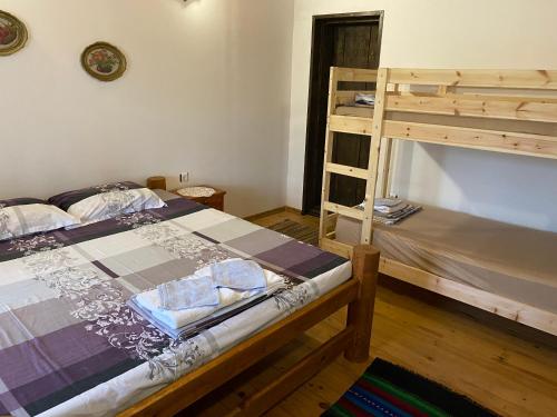 a bedroom with two bunk beds and a ladder at Под старата липа in Goritsa