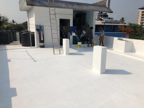 a person standing on the roof of a building at Mukalel Tourist Home in Ernakulam