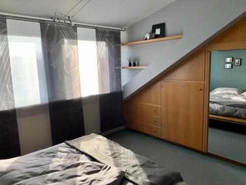 a bedroom with a bed and a stair case at MEINE OASE Ferienwohnung !!! NICHT FÜR MONTEURE !!! in Horn-Bad Meinberg