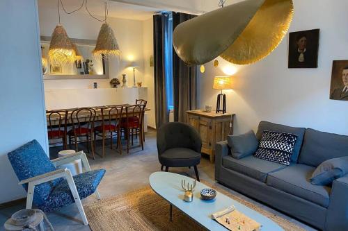 un salon avec un canapé et une salle à manger dans l'établissement A l'ombre d'Armandii, à Châlons-en-Champagne