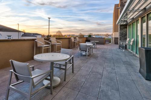 a patio with tables and chairs on a building at Holiday Inn Express & Suites Wooster by IHG in Wooster