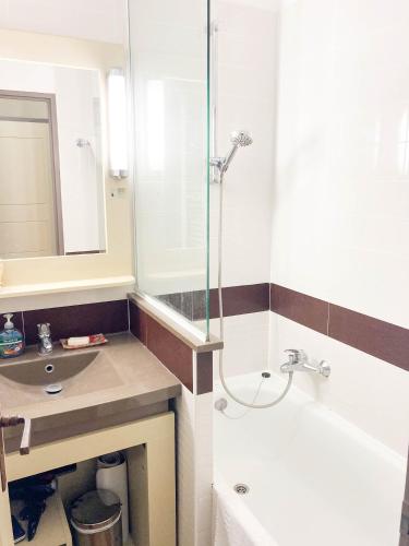 a bathroom with a shower and a sink and a tub at Residence Cap Esterel Babou in Saint-Raphaël