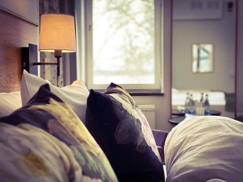 a bedroom with a bed with pillows and a window at Wiks Slott in Vik