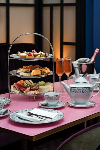 a pink table with food and glasses of wine at The Savoy Hotel in Limerick