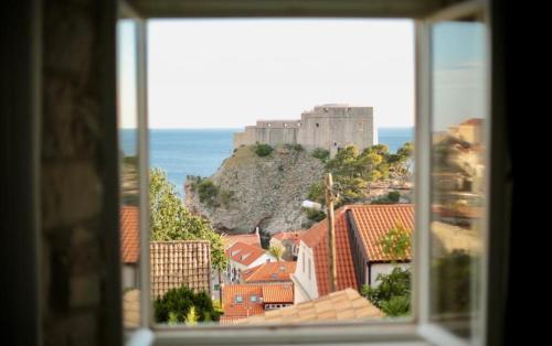 a view of a castle from a window at Apartments Cava Dubrovnik in Dubrovnik