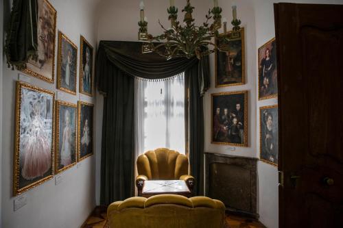 a living room with a chair and a window at Tündérkert Hotel Noszvaj in Noszvaj